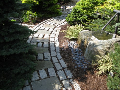 fountain-with-copper-spout next to a path to meditation